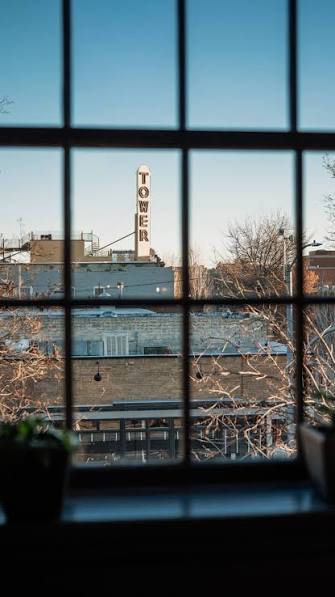 The Tower Theatre sign, downtown Bend, seen through a clean window